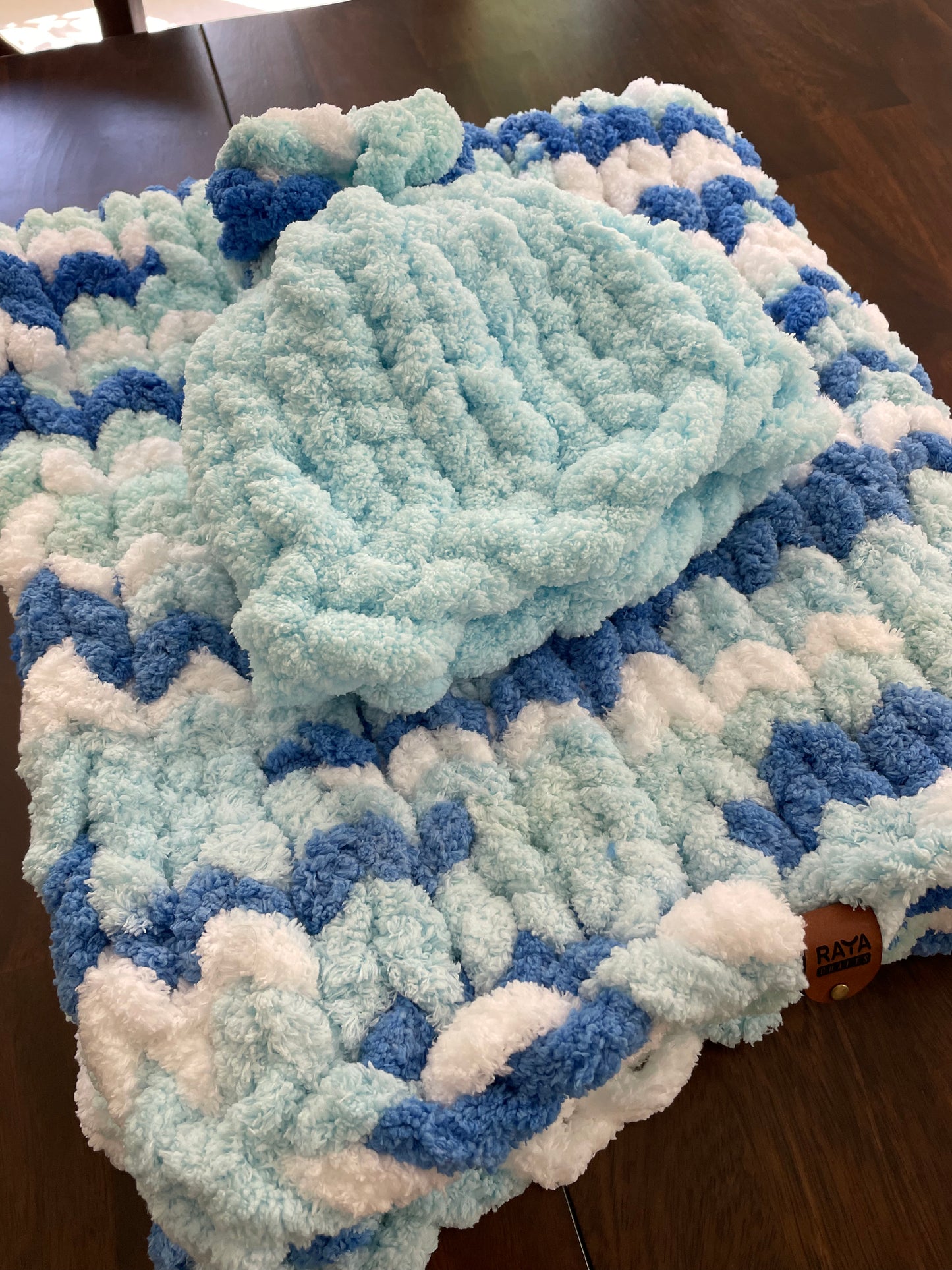 Handmade blanket made with love of 100% soft and cozy polyester chunky chenille yarn, a gift for a cute baby.