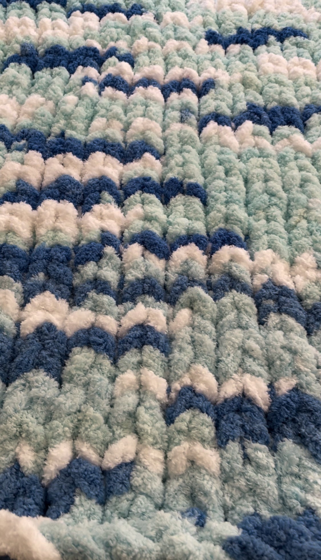 Handmade blanket made with love of 100% soft and cozy polyester chunky chenille yarn, a gift for a cute baby.